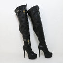 Black high-heeled boots with chain details on a white background, branded 'Obroi'.