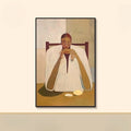 Framed abstract artwork of a figure draped in white with a chair and table on a beige wall, Obroi