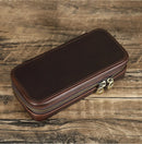 Brown leather wallet with a gold zipper on a wooden surface, Obroi