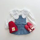 Children's outfit with denim overalls, white blouse, red hat, and mittens on a light gray background, Obroi