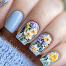 Nails with floral design featuring flowers and beads on a light blue background, Obroi