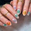 Close-up of hands with colorful nail art on a neutral background, Obroi