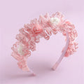 Pink lace headband with floral details on a light pink background, Obroi
