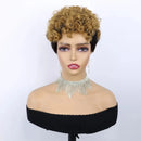 A short curly wig with a warm golden-brown ombre transition and dark roots, displayed on a mannequin bust wearing a black off-the-shoulder top and a rhinestone choker necklace against a plain white background, Obroi