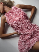 Woman wearing a pink floral dress lying on a white surface, Obroi
