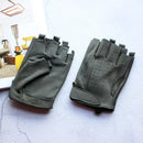 Pair of green fingerless gloves on a textured surface with a blurred indoor setting in the background, Obroi