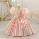 Pink dress on a mannequin against a decorative background, Obroi