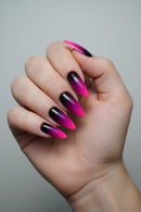 Hand with pink and black gradient nail design on a neutral background, Obroi