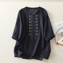 Black blouse with embroidery on a light beige background, Obroi