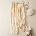 Beige pants with a white handbag and shoes on a light beige background, Obroi