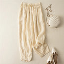 Beige pants with a white handbag and shoes on a light beige background, Obroi