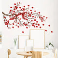 Red floral wall decal on a white wall with a dining table and chairs in the foreground, Obroi