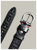 Black leather belt with intricate designs and a silver buckle on a gray background, Obroi