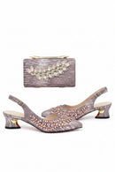 Pair of embellished shoes with matching handbag on a white background, Obroi