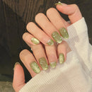 Hand with green nail polish holding a white fabric, Obroi