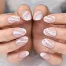Close-up of hands with pink and white marbled nail polish on a neutral background, Obroi