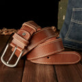 Brown leather belt with silver buckle on a wooden surface, Obroi