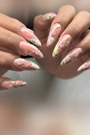 Nails with floral design held by a person, Obroi