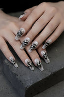 Close-up of hands with decorative nail art on a dark surface, Obroi