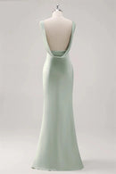 Mint green evening gown on a mannequin against a light gray background