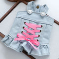 Denim dress with pink laces and heart-shaped buttons on a white background, Obroi
