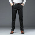 Person wearing black dress pants with a gray background, Obroi
