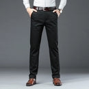 Person wearing black dress pants with a gray background, Obroi