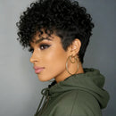 Woman with short, curly black hair wearing a green hoodie against a gray background, Obroi