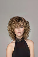 Woman with styled blonde hair against a neutral background, Obroi