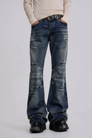 Person wearing blue flared jeans on a plain background, Obroi
