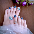  toes with decorative nail art and rings on a neutral background, Obroi