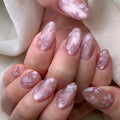 Close-up of a hand with pink floral nail design on a soft background, Obroi