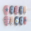 Set of handmade nails with various designs on a white background, Obroi