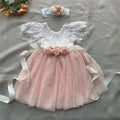 Pink and white lace dress with floral headband on a gray surface, Obroi