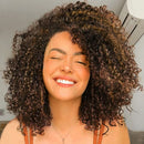 Woman with curly hair smiling indoors, Obroi