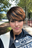 Woman with a stylish haircut outdoors in a park-like setting, Obroi
