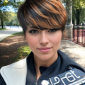 Woman with a stylish haircut outdoors in a park-like setting, Obroi