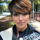 Woman with a stylish haircut outdoors in a park-like setting, Obroi