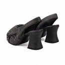 Black high-heeled shoes with studded details on a white background, Obroi