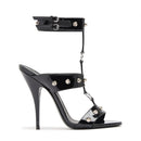 Black high-heeled sandal with studded details on a white background, featuring the Obroi brand.
