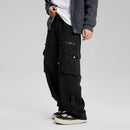 Person wearing black cargo pants on a gray background, Obroi