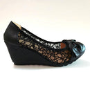 Black wedge shoe with lace detailing and a bow on a white background, Obroi