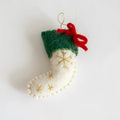 Felt Christmas stocking ornament with gold snowflake details and a red bow on a white , Obroi
