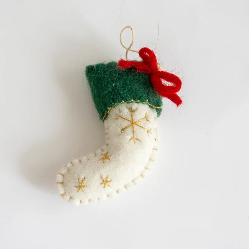 Felt Christmas stocking ornament with gold snowflake details and a red bow on a white , Obroi