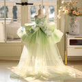 Green floral dress on a mannequin in a room with a window and vase of flowers, Obroi