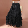 Black lace skirt on a hanger against a brown background, Obroi