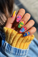 Colorful nail art on a hand with a blurred background, Obroi