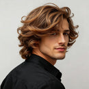 Man with styled hair wearing a black shirt against a neutral background, Obroi