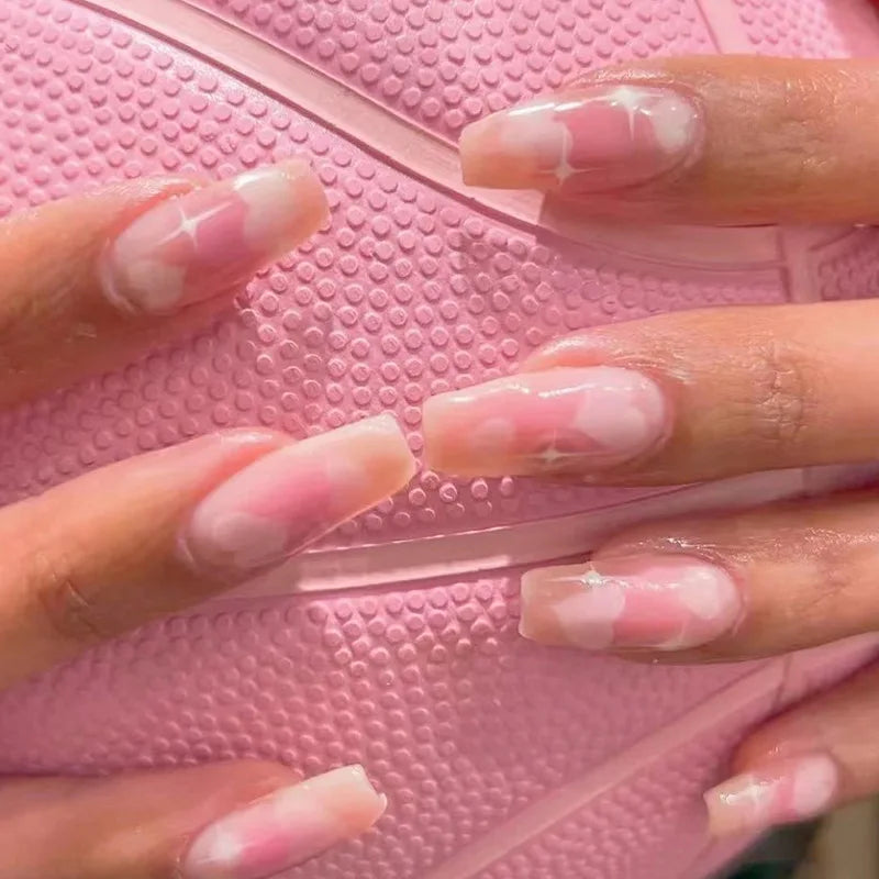 Obroi Close-up of hands with pink and white nail polish on a pink textured background