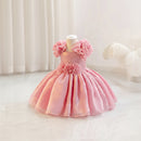 Pink children's dress with floral details on a mannequin against a white background, Obroi